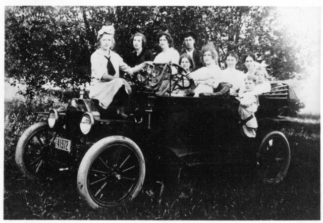 This is the family's first car, a 1914 Ford. On the right are William and June in the car, with Lucy standing next to none other than Aunt Josie! On the far left is Marian. Esther is in the driver's seat. About 1915. (Original: Janet Lucius)