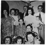 Dated as December 1954, based on another picture showing William and Lucy in same clothes, with "Dec 1954" on back. Caption on back of this one says "1954".  Standing left to right: June (Bundy) Winberg, Marion (Bundy) Lingenfelter, Pete Stuhr, Royal Lingenfelter, Sharon and Dawn, William Bundy. Lucy Bundy in center. Sitting, left to right: Mary Winberg, Pat Stuhr, Florence, Ruth holding Joan Winberg. (Original: Janet Lucius)