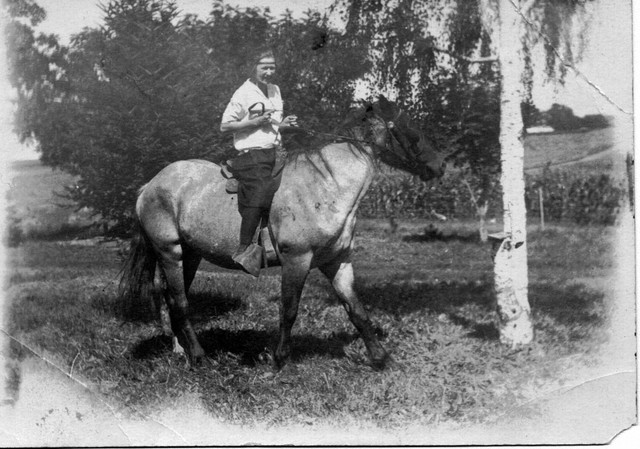Marion Bundy riding a horse on the Oak Center farm.  Around 1920.  (Original: Mary Hundeby)