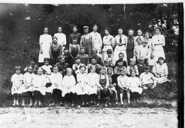 Oak Center class picture.  June Bundy is in the front row, far left, marked with an X.  On the far right, marked with an X, is Ruth.  Marion is in the back row, also marked with an X.  The girl in the back row second from right marked with an X is so far unidentified.(Original: Mary Hundeby)