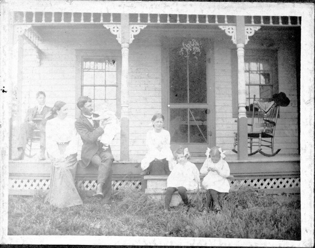 Lindsay sitting on porch, then Lucy, Francis holding June, Esther, Ruth, and Marion.  Picture taken at Benjamin and Ida Boughton's house in Bear Valley, around 1908. Scanned from an original in 2004.  (Original: Mary Hundeby.)
