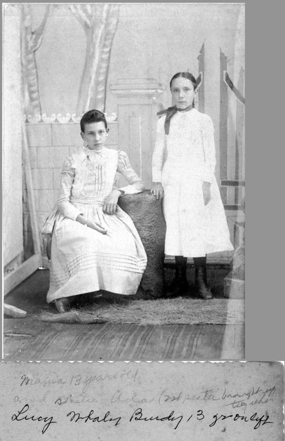 Lucy Whaley, 13 years old on left, and her step-sister, Ada Segar on the right, about 1892. Both were raised by Benjamin Boughton and his wife Ida (Segar) Boughton. On the back is written in June Bundy's handwriting: "Mama 13 years old, and sister Ada (not sister brought up together)" and in Lucy Bundy's handwriting: "Lucy Whaley Bundy 13 yr. on left". (Original: Mary Hundeby)