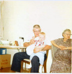 Bob Hart on the lap of Bob Winberg, next to Bob Winberg's mother Clara Winberg (Original: Mary Hundeby)