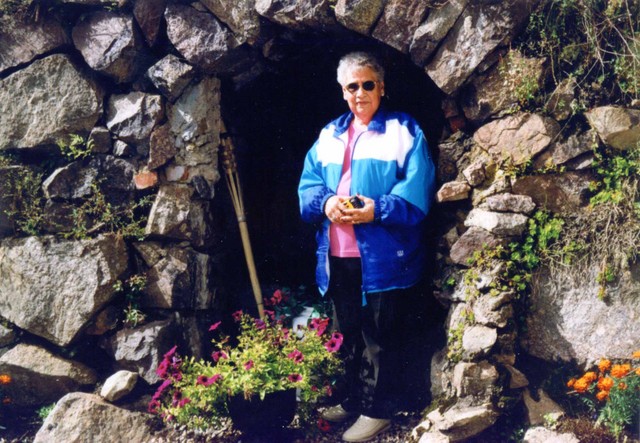 From Donna and Leota's letter: "This is Aunt Anna standing in the entrance to the root cellar built into a hill that belongs to the yellow house." (Original: Joan Collinge)